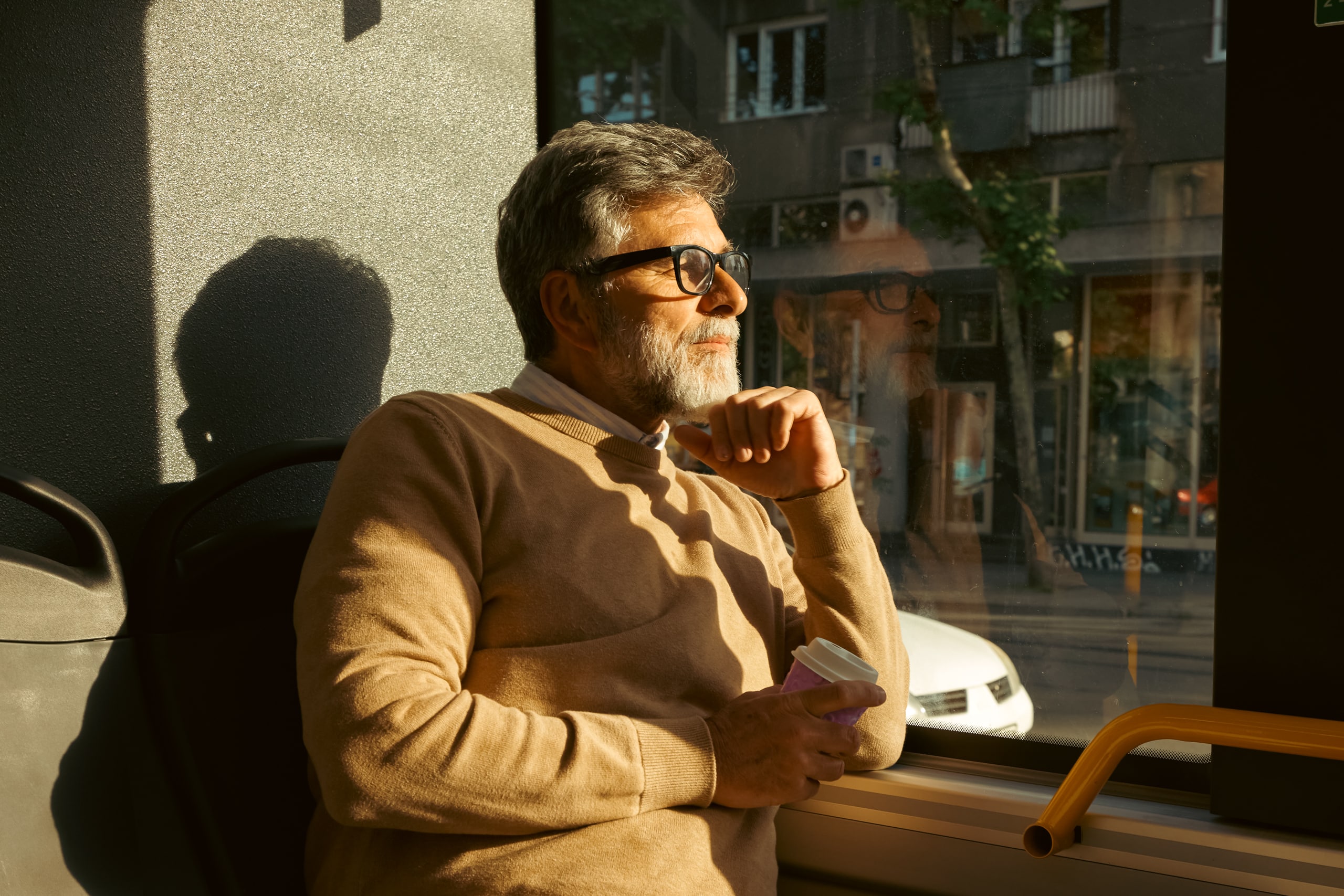 An older man in Florida reflecting peacefully on his gambling recovery journey with Playwise.