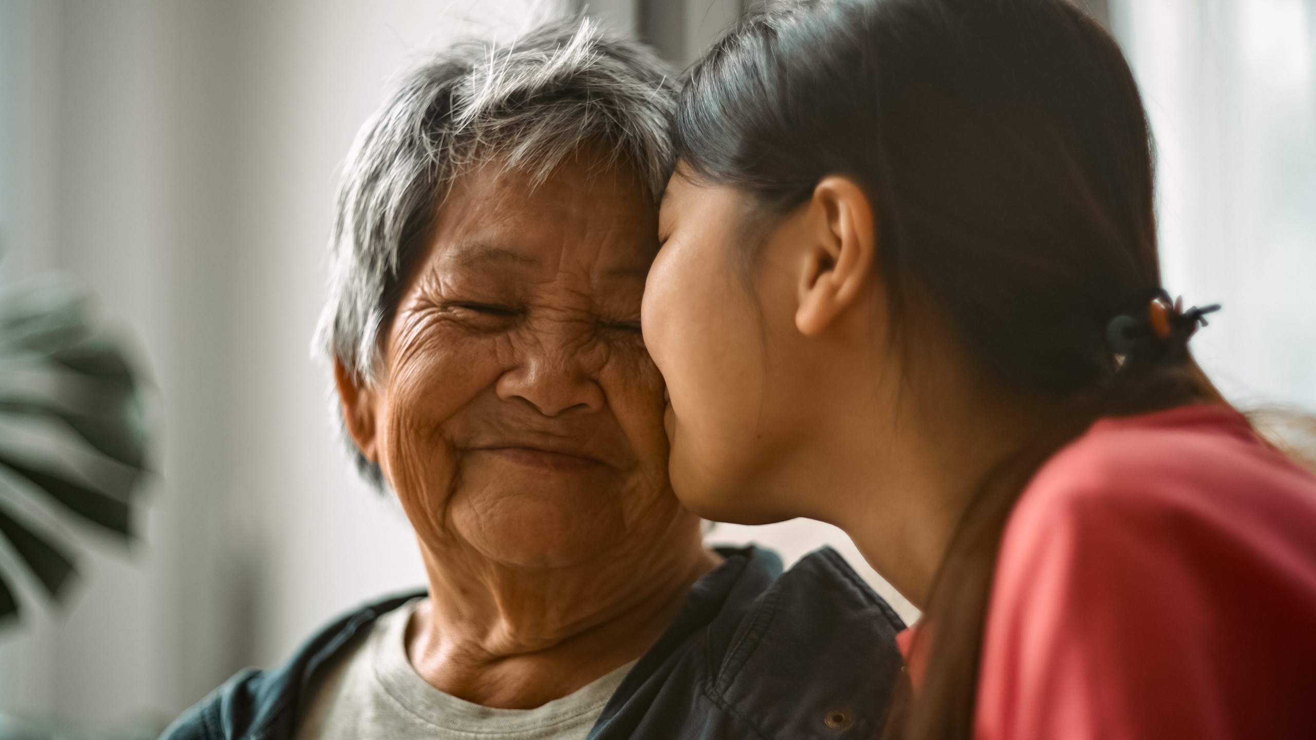 An older woman in Florida being comforted by a family member, highlighting family support in gambling recovery.